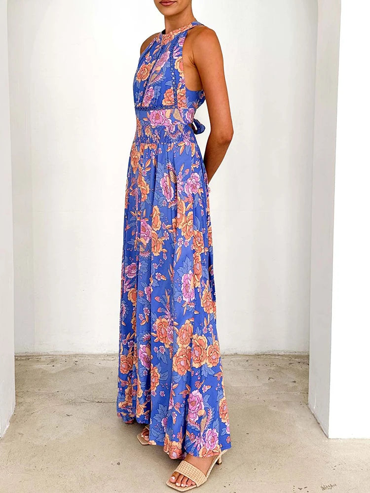 Blue floral sleeveless maxi dress with high neckline and gathered tiered skirt