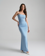 Light blue spaghetti strap maxi dress with ruched center and mermaid-style hem.