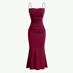 Dark red spaghetti strap maxi dress with ruched bodice and fitted long skirt.