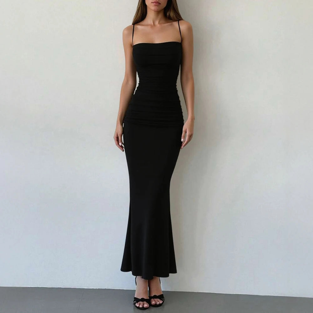 Black spaghetti strap maxi dress with gathered bodice and long fitted mermaid hem.