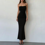 Black spaghetti strap maxi dress with gathered bodice and long fitted mermaid hem.