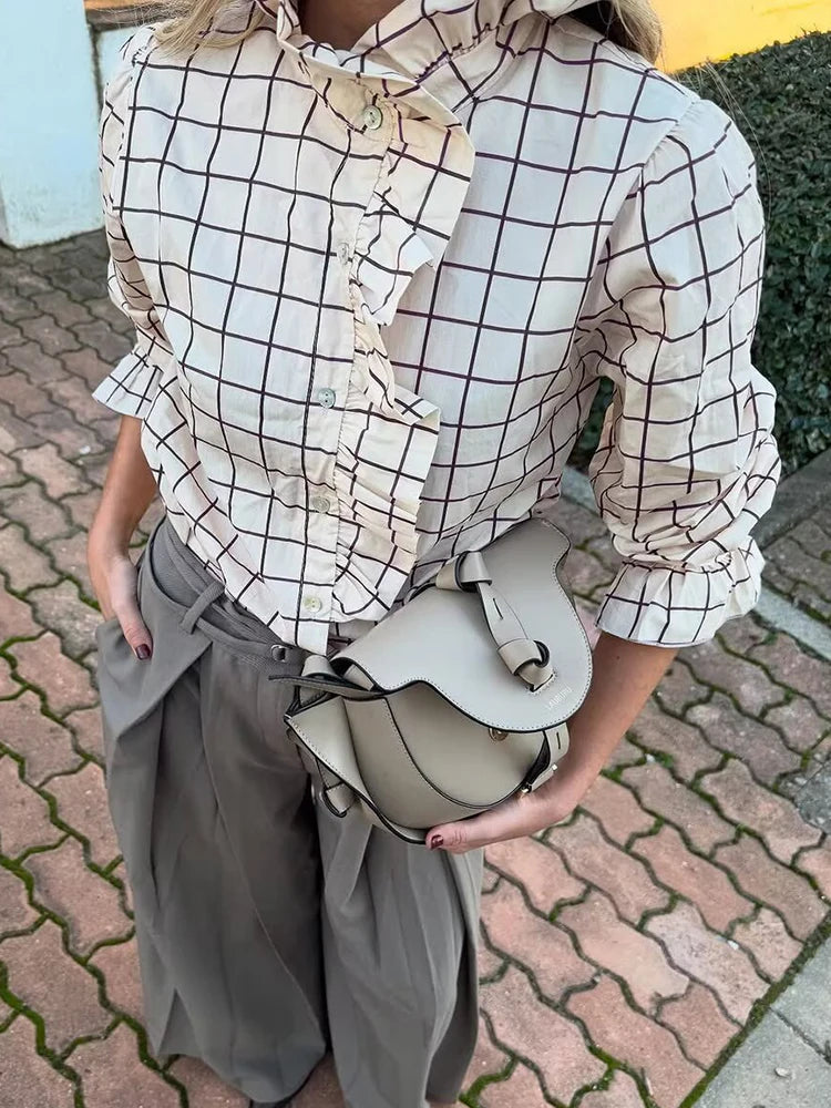 Women’s checked blouse close-up with ruffle detail on the button front