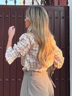 Women’s checked blouse with ruffled high neck and button front