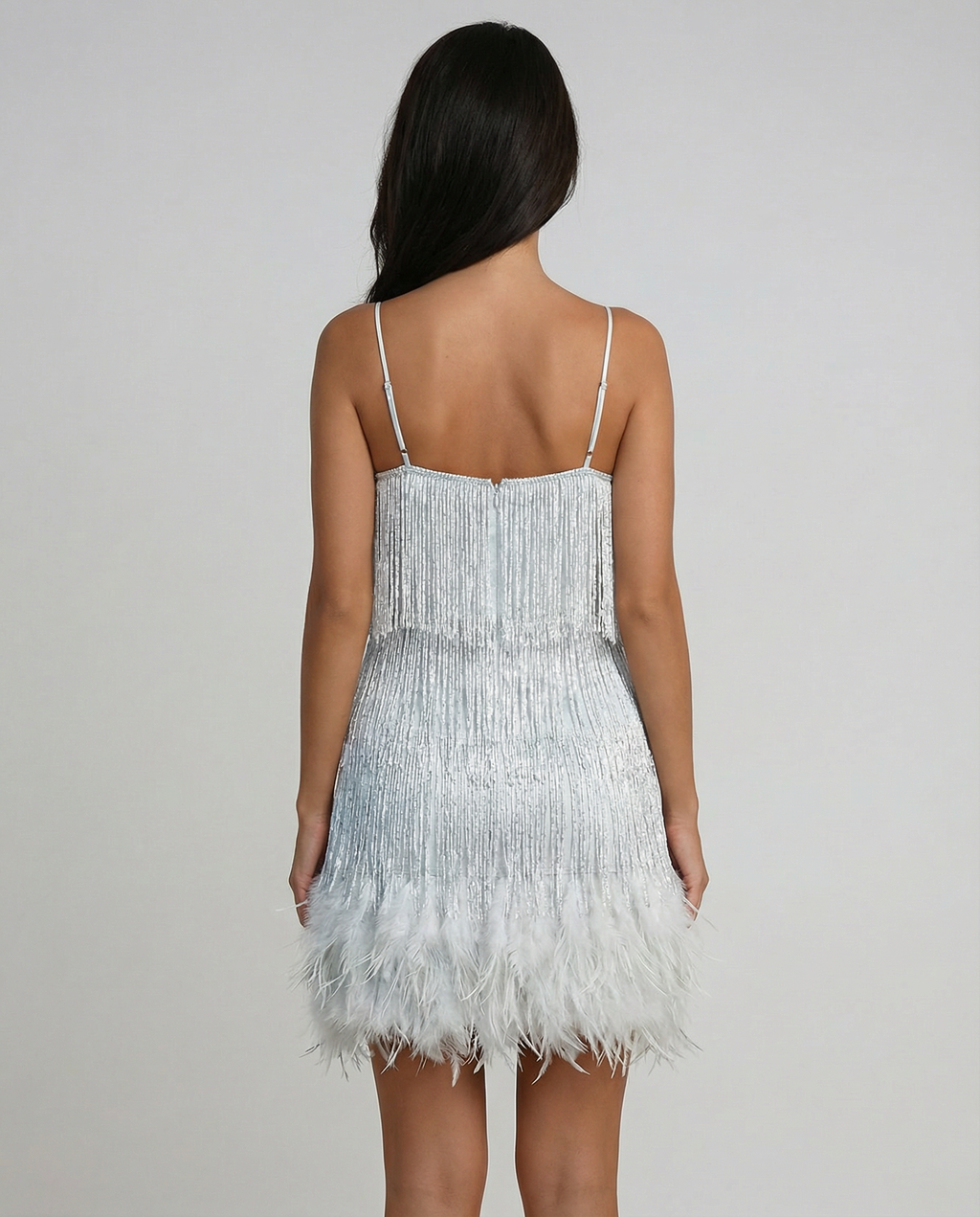Silver mini dress with spaghetti straps and feather fringe hem, full back view