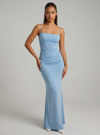 Light blue spaghetti strap maxi dress, ruched waist and floor-length fitted silhouette.