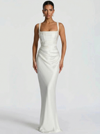 White backless maxi dress with square halter neckline, fitted satin with draped side detail
