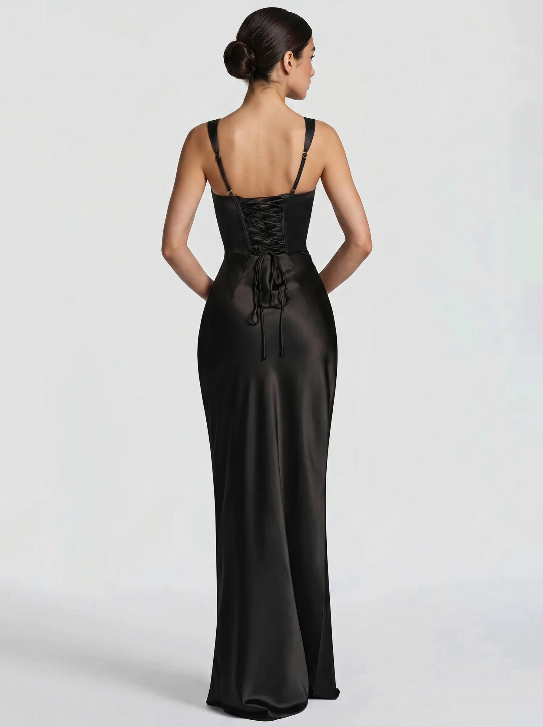 Black backless maxi dress with thin spaghetti straps and open back, smooth satin skirt