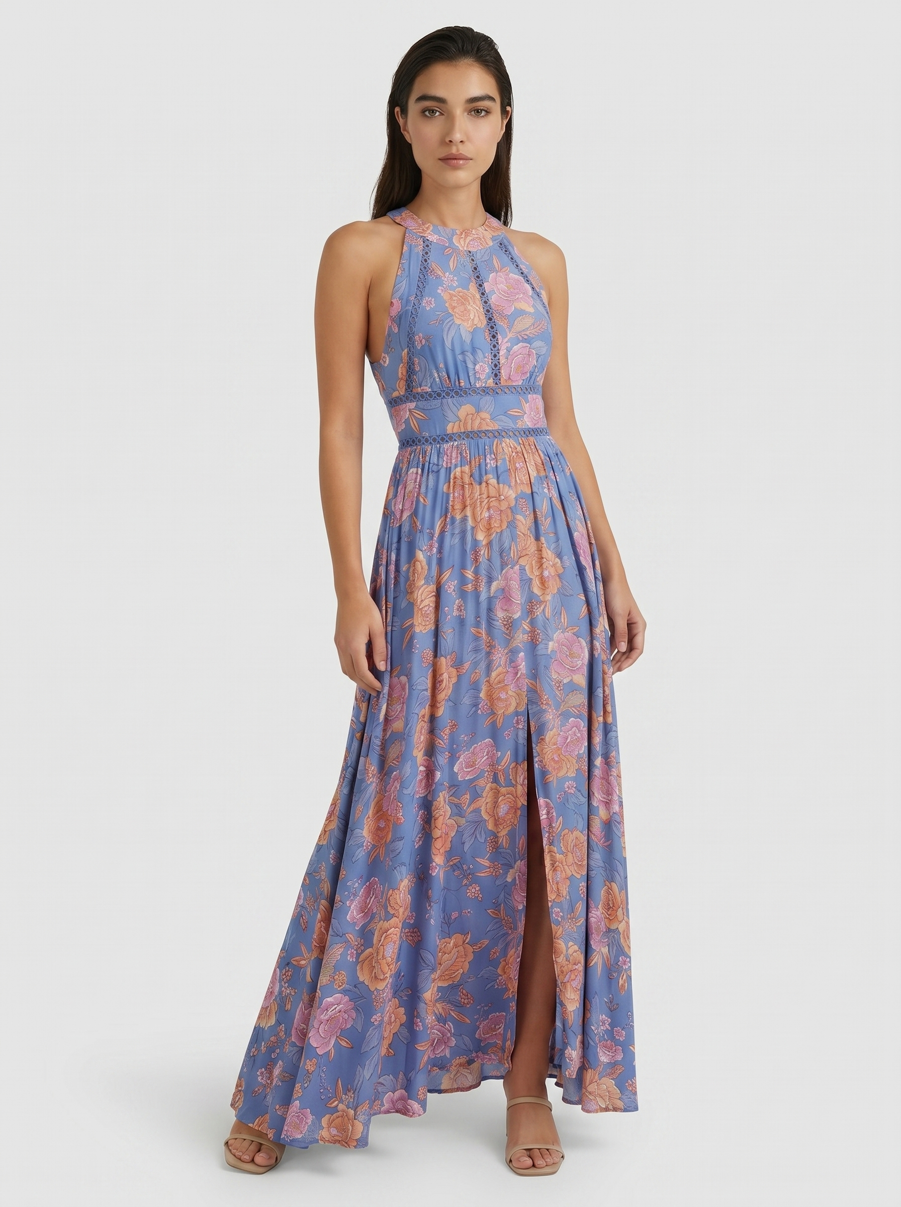 Blue floral sleeveless maxi dress with high neckline, smocked waist, and tiered skirt
