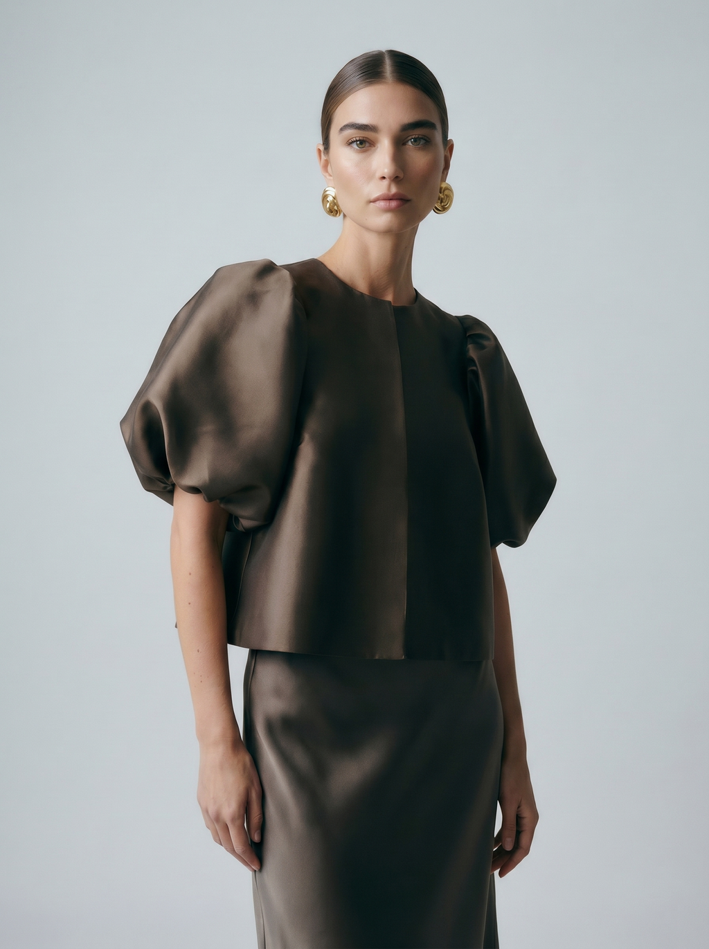 Dark satin puff sleeve blouse with front button placket and crew neck