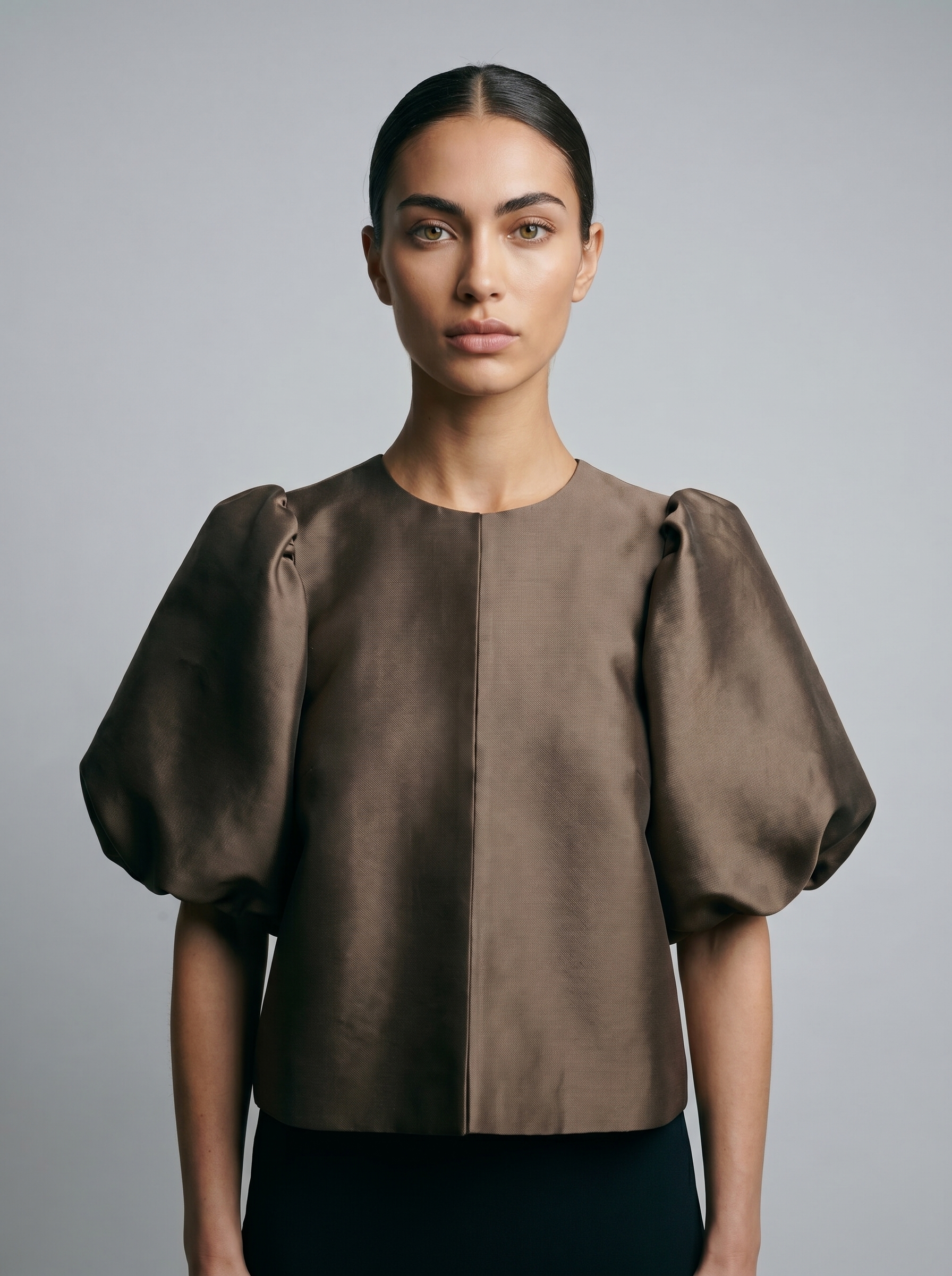 Brown puff sleeve blouse with front button placket and rounded neckline