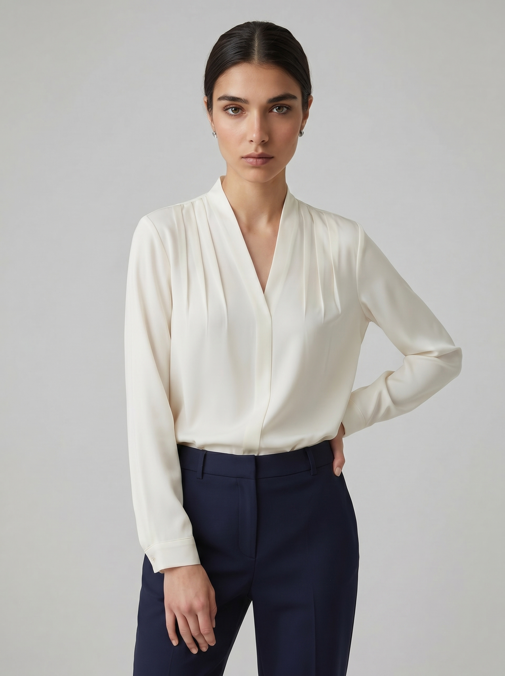 Ivory V-neck puff-sleeve blouse with defined waist and cuffed long sleeves
