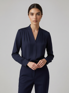 Navy blue puff-sleeve blouse with tailored defined waist and V-neck front