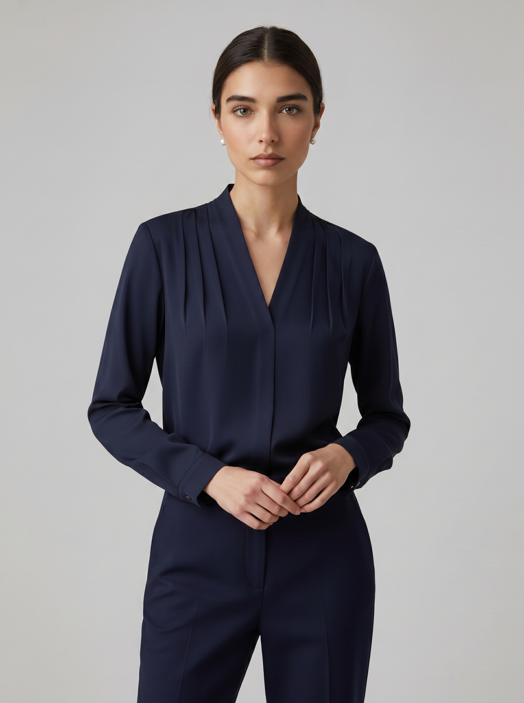 Navy blue puff-sleeve blouse with tailored defined waist and V-neck front